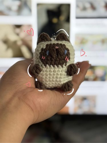 Siamese cat keychain I crocheted, in my hand