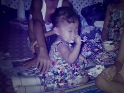 Me as a toddler, happily eating cake